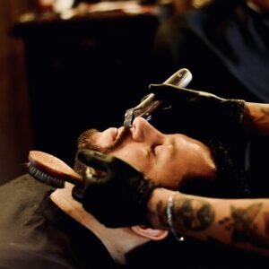 man in black shirt holding smartphone